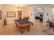 Bright game room features a pool table, tile floors, and is surrounded by arches open to other living spaces at 11314 Ledgement Ln, Windermere, FL 34786