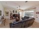 Spacious living room featuring tile flooring, ceiling fan, and large windows at 11314 Ledgement Ln, Windermere, FL 34786