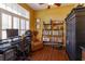 Inviting home office with wood floors, a large window, a comfortable chair, and a custom bookcase at 11314 Ledgement Ln, Windermere, FL 34786