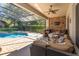 A covered outdoor patio with a lounge area, bar, and pool access at 11314 Ledgement Ln, Windermere, FL 34786