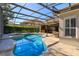 An enclosed pool with a hot tub, patio, and seating area in a backyard at 11314 Ledgement Ln, Windermere, FL 34786