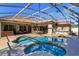 An enclosed pool with a hot tub, patio, and outdoor seating at 11314 Ledgement Ln, Windermere, FL 34786