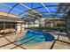 An enclosed pool with a hot tub, patio, and well-maintained lawn at 11314 Ledgement Ln, Windermere, FL 34786