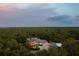 Stunning home with lush landscaping and beautiful architecture, enveloped by picturesque natural scenery at 11450 Nellie Oaks Bnd, Clermont, FL 34711