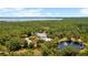Beautiful home with a pond and fountain, nestled on wooded acreage, offering privacy and tranquility at 11450 Nellie Oaks Bnd, Clermont, FL 34711