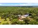 Expansive estate with a luxurious home, guest house, and a serene pond featuring a fountain at 11450 Nellie Oaks Bnd, Clermont, FL 34711