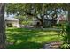 Lush backyard featuring a patio, a fountain, and mature trees, offering a serene outdoor living space at 11450 Nellie Oaks Bnd, Clermont, FL 34711