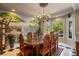 Formal dining room featuring an elegant chandelier, custom mural, and views of the front yard at 11450 Nellie Oaks Bnd, Clermont, FL 34711