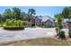 Stunning home featuring a circular driveway, fountain, manicured landscaping, and porte cochere at 11450 Nellie Oaks Bnd, Clermont, FL 34711