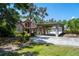 This elegant home features lush landscaping, porte cochere, and a circular driveway for added convenience at 11450 Nellie Oaks Bnd, Clermont, FL 34711