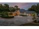 Beautiful home with well-manicured landscaping, a circular driveway, and an attractive water fountain at 11450 Nellie Oaks Bnd, Clermont, FL 34711