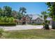 Beautiful home with lush landscaping, porte cochere, and a circular driveway creates an inviting entry at 11450 Nellie Oaks Bnd, Clermont, FL 34711