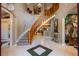 Spacious foyer featuring an elegant staircase and decorative tile flooring at 11450 Nellie Oaks Bnd, Clermont, FL 34711