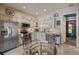 Well-lit kitchen featuring modern appliances, light cabinets, and a cozy breakfast nook at 11450 Nellie Oaks Bnd, Clermont, FL 34711
