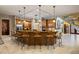 Spacious kitchen with a large center island, bar seating, and wood cabinetry at 11450 Nellie Oaks Bnd, Clermont, FL 34711