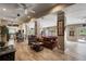 Open concept living space with hardwood floors, exposed beams, and view of pool table at 11450 Nellie Oaks Bnd, Clermont, FL 34711