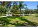 Green lawn with pond featuring fountain, gazebo and decorative arch at 11450 Nellie Oaks Bnd, Clermont, FL 34711
