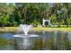 Scenic view of a fountain pond with decorative arch in the background at 11450 Nellie Oaks Bnd, Clermont, FL 34711