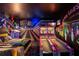 This fun recreation room features a mural, neon lighting, bowling games, and an unique design at 11450 Nellie Oaks Bnd, Clermont, FL 34711