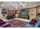 Entertainment room featuring movie decor, plush seating, and a large flat screen TV at 11450 Nellie Oaks Bnd, Clermont, FL 34711