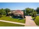 Sprawling property featuring lush landscaping, mature trees and an expansive driveway at 11720 Indian Hills Ln, Clermont, FL 34711