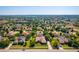 This aerial shot shows the home nestled within a quiet community lined with mature trees and manicured lawns at 11720 Indian Hills Ln, Clermont, FL 34711
