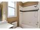Bright bathroom featuring a shower-tub combination with a modern design at 11720 Indian Hills Ln, Clermont, FL 34711