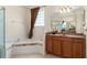 Bathroom features a soaking tub with tile surround and natural light at 11720 Indian Hills Ln, Clermont, FL 34711