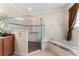Well-lit bathroom features a glass shower, soaking tub, and tile floors at 11720 Indian Hills Ln, Clermont, FL 34711