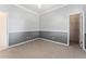 Spacious bedroom with neutral carpet, half painted walls, and closet access at 11720 Indian Hills Ln, Clermont, FL 34711