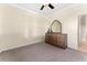Bedroom with neutral walls, ceiling fan, and a dresser with mirror at 11720 Indian Hills Ln, Clermont, FL 34711