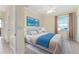 Bright bedroom with cool blues, a ceiling fan, and a large window at 11720 Indian Hills Ln, Clermont, FL 34711