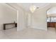 Open dining area featuring neutral tile flooring and chandelier at 11720 Indian Hills Ln, Clermont, FL 34711