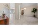 Open dining area featuring neutral tile flooring and chandelier at 11720 Indian Hills Ln, Clermont, FL 34711