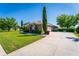 A well-manicured front lawn and beautiful landscaping lead to a three-car garage in this single-Gathering home at 11720 Indian Hills Ln, Clermont, FL 34711