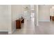 Bright foyer with neutral tile flooring, light walls, and an elegant console table at 11720 Indian Hills Ln, Clermont, FL 34711