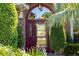 Inviting front entrance with decorative glass door, framed by lush greenery and stone accents at 11720 Indian Hills Ln, Clermont, FL 34711