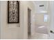 Hallway leading to a carpeted bedroom with bright natural light at 11720 Indian Hills Ln, Clermont, FL 34711