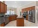 Bright kitchen with stainless steel appliances, center island, and dark countertops at 11720 Indian Hills Ln, Clermont, FL 34711