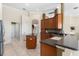 Well-equipped kitchen featuring an island, dark countertops, mosaic backsplash and wood cabinets at 11720 Indian Hills Ln, Clermont, FL 34711