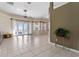 Bright living room with tile floors, ceiling fan, and french doors to the balcony at 11720 Indian Hills Ln, Clermont, FL 34711
