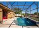 Backyard pool with a screened enclosure and tiled water features at 11720 Indian Hills Ln, Clermont, FL 34711