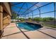 Inviting pool area with a screened enclosure and serene fountain features at 11720 Indian Hills Ln, Clermont, FL 34711
