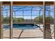 View from home to screened-in pool and landscaped backyard at 11720 Indian Hills Ln, Clermont, FL 34711