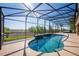 Lovely screened pool with scenic views and sunlit lounging area at 11720 Indian Hills Ln, Clermont, FL 34711