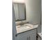 Bathroom features a framed mirror and granite vanity at 13075 Se 35Th Ct, Belleview, FL 34420