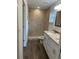 Tiled bathroom with granite vanity and walk-in shower at 13075 Se 35Th Ct, Belleview, FL 34420