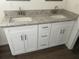 Close-up view of the double sink vanity with granite countertops at 13075 Se 35Th Ct, Belleview, FL 34420