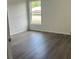 Bedroom features new wood flooring and a window at 13075 Se 35Th Ct, Belleview, FL 34420