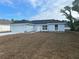 Charming single-story home with a well-manicured lawn and a two-car garage at 13075 Se 35Th Ct, Belleview, FL 34420